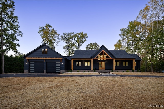 modern inspired farmhouse with driveway and a garage