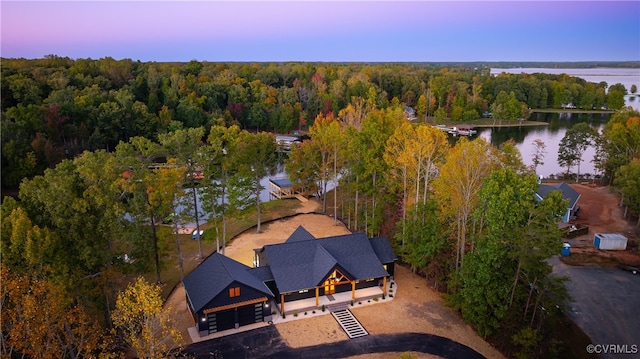 aerial view featuring a water view and a forest view