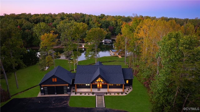 aerial view at dusk with a water view