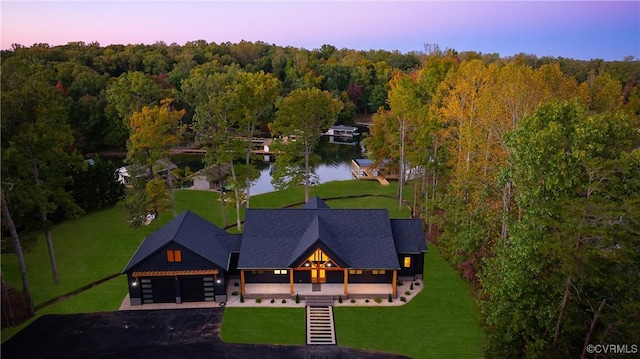 birds eye view of property with a view of trees