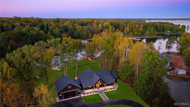 drone / aerial view with a water view and a wooded view