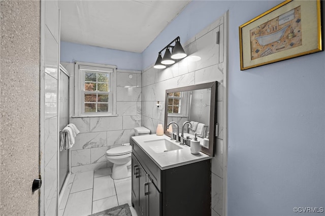 bathroom featuring tile walls, walk in shower, vanity, and toilet