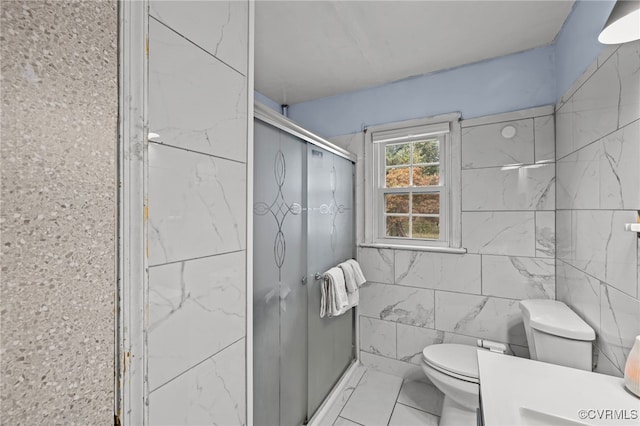 bathroom with toilet, tile walls, and walk in shower