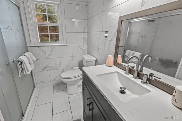 bathroom featuring tile walls, vanity, and toilet