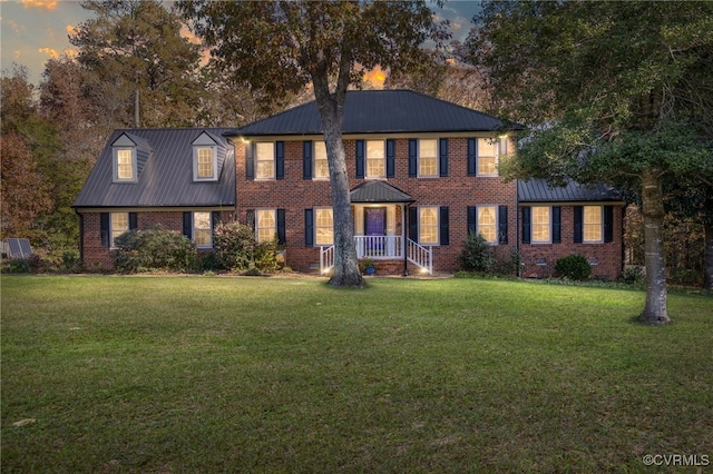 colonial inspired home featuring a lawn