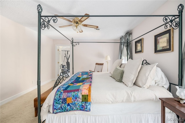 carpeted bedroom with a textured ceiling and ceiling fan