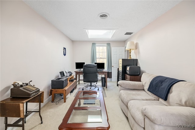 living room featuring carpet floors and a textured ceiling