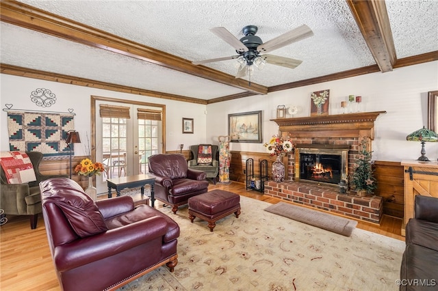 living room with french doors, crown molding, a textured ceiling, beamed ceiling, and wood-type flooring