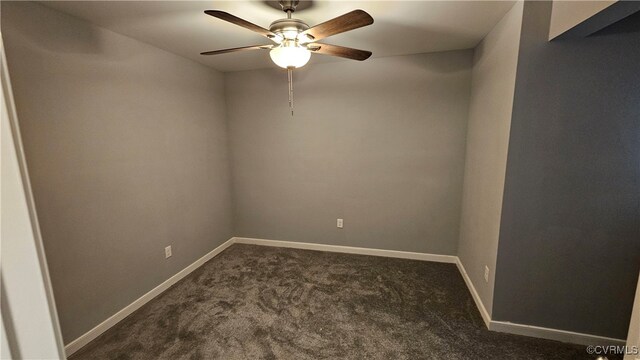 spare room featuring ceiling fan and dark carpet