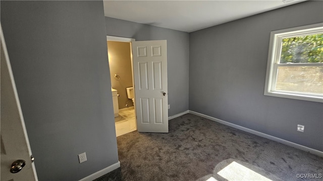 unfurnished bedroom featuring dark carpet