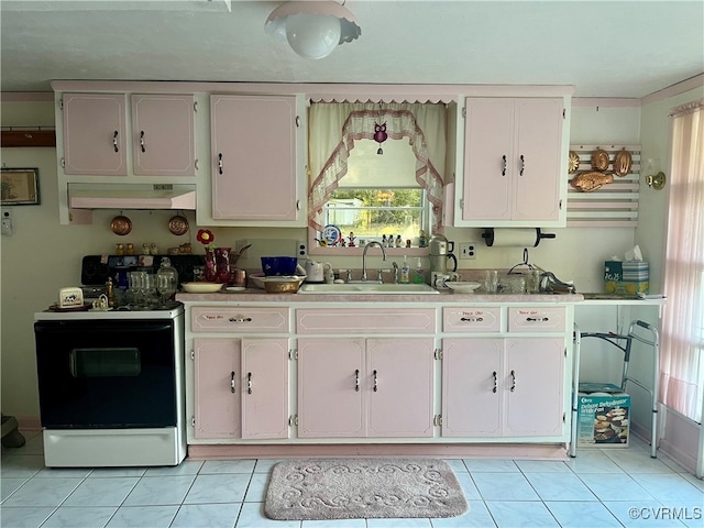 kitchen with light tile patterned flooring, white electric range oven, sink, and white cabinets