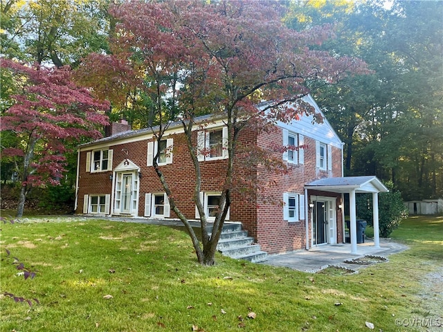 view of front of house with a front lawn and a patio area