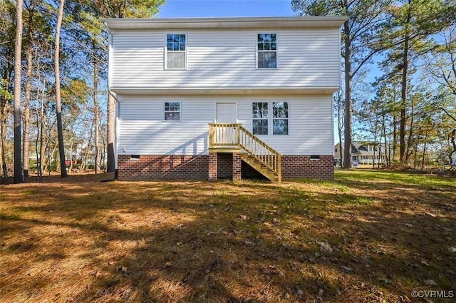 rear view of property with a lawn