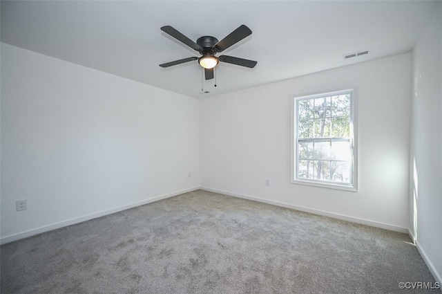 spare room with ceiling fan and carpet flooring