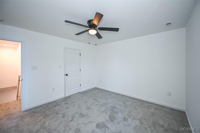 spare room with ceiling fan and light carpet