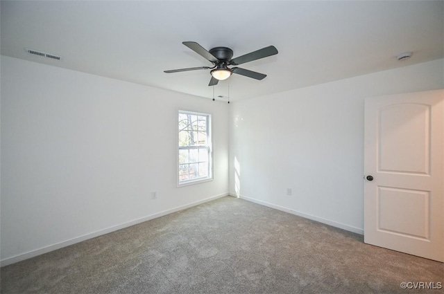 empty room featuring carpet flooring and ceiling fan