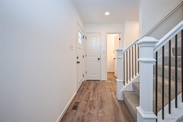 hallway with hardwood / wood-style flooring