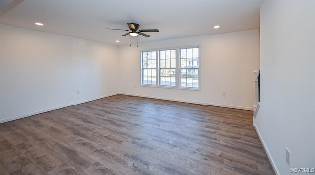 unfurnished room with dark wood-type flooring and ceiling fan