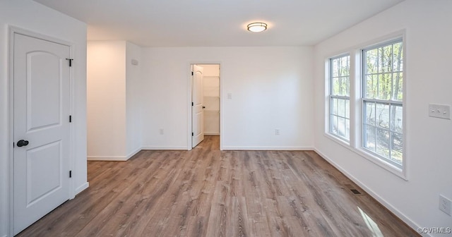 unfurnished room featuring light wood-type flooring