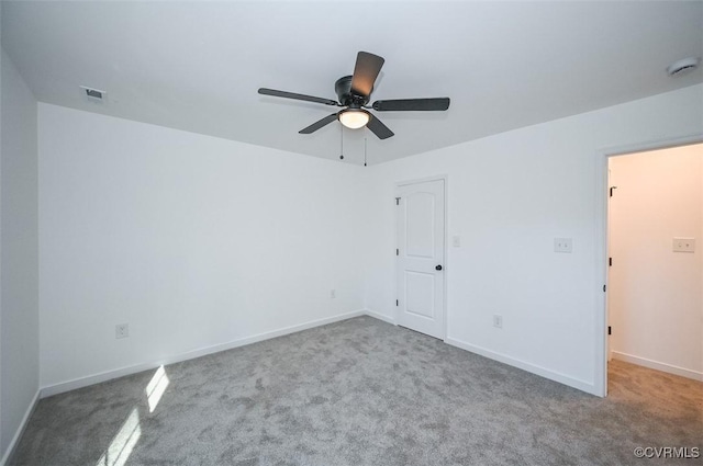 empty room with ceiling fan and light colored carpet