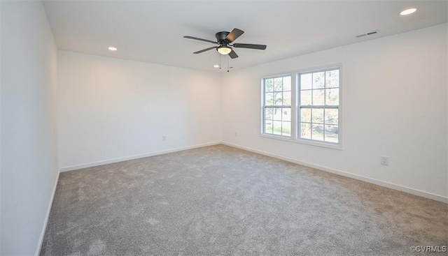 spare room featuring ceiling fan and carpet flooring