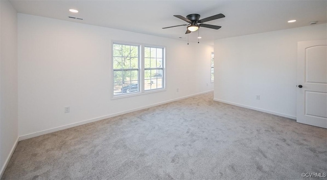 carpeted empty room featuring ceiling fan