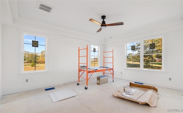 playroom featuring ceiling fan and a raised ceiling