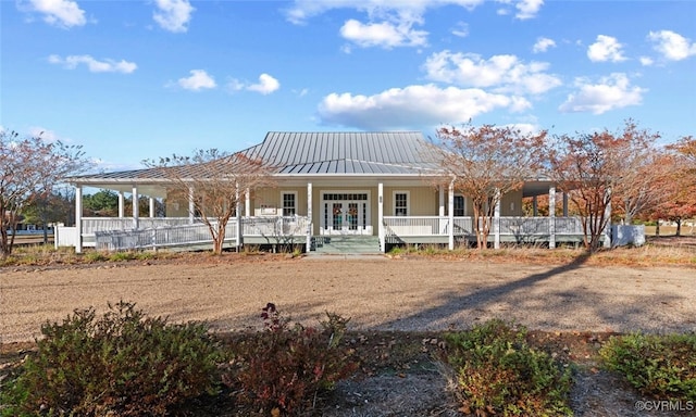 view of front of house featuring a porch and french doors