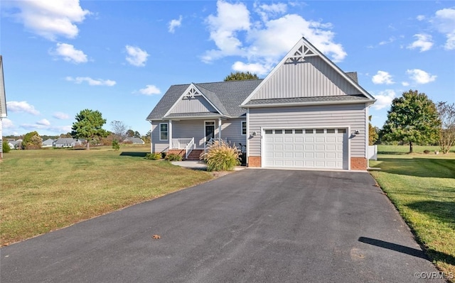 view of front of home with a front yard and a garage