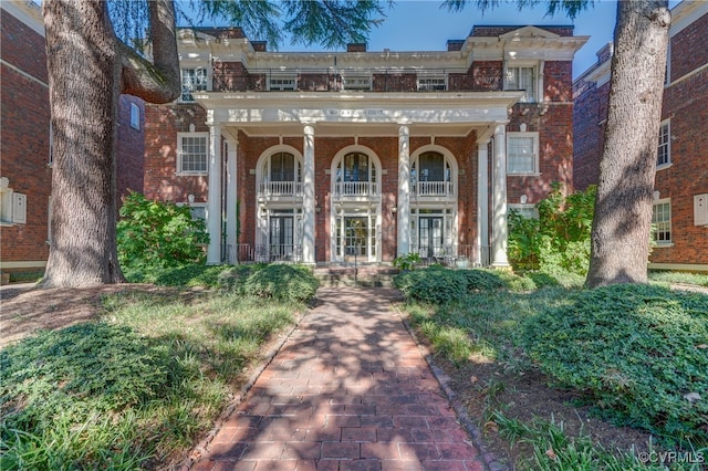 view of exterior entry featuring a balcony