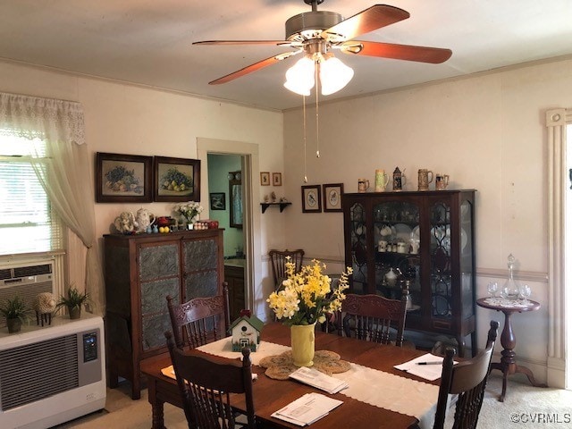 carpeted dining room with ceiling fan