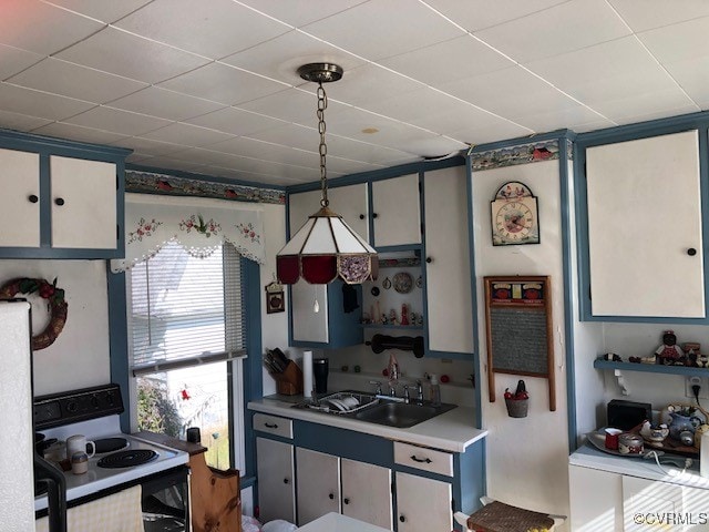 kitchen with white cabinetry, white appliances, sink, and pendant lighting