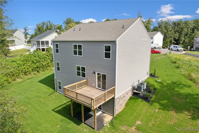 back of property with central AC, a wooden deck, and a yard