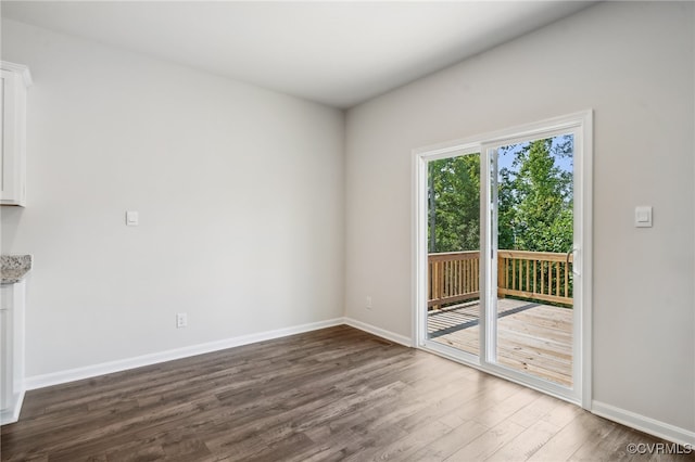 empty room with dark hardwood / wood-style flooring