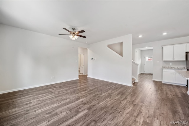 unfurnished living room with hardwood / wood-style floors and ceiling fan