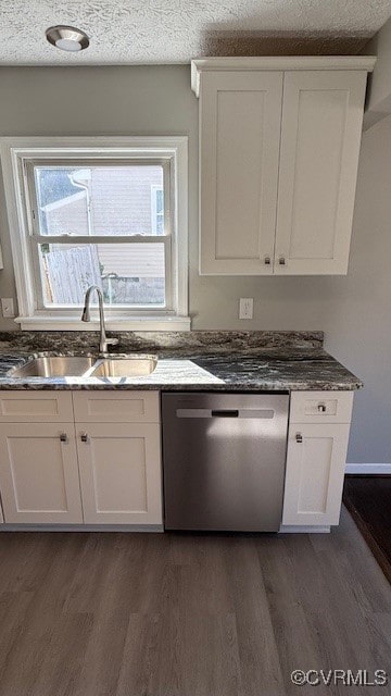 kitchen with white cabinets, a textured ceiling, stainless steel dishwasher, dark hardwood / wood-style floors, and sink