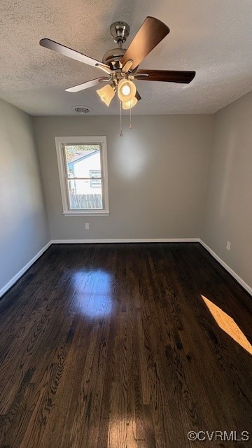 unfurnished room featuring dark wood-type flooring, ceiling fan, and a textured ceiling