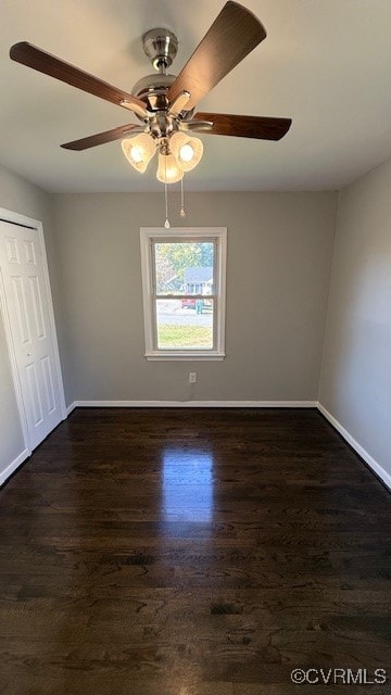 unfurnished room with ceiling fan and dark hardwood / wood-style flooring