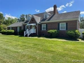 new england style home featuring a front yard