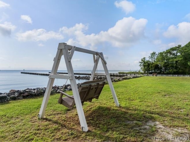 view of play area with a water view and a lawn