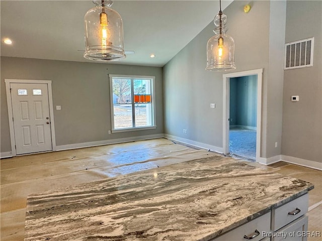 unfurnished dining area with vaulted ceiling