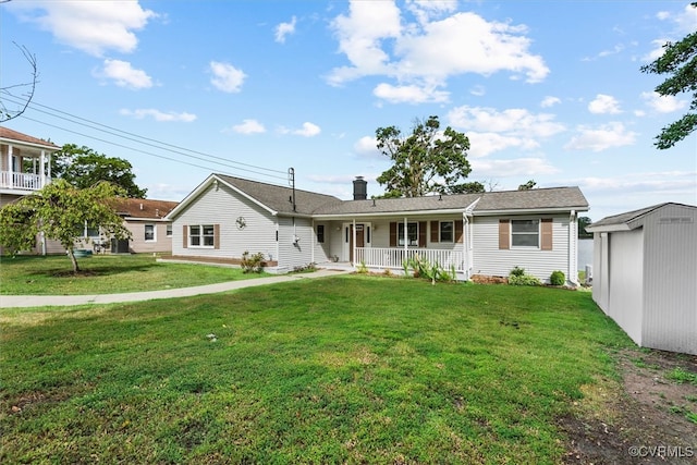 ranch-style house featuring covered porch, a storage unit, and a front lawn