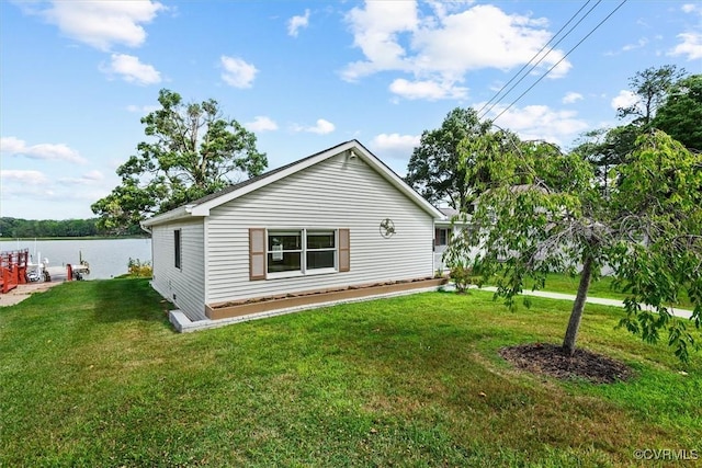 back of property featuring a water view and a yard