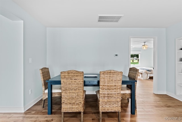 dining area featuring hardwood / wood-style flooring and ceiling fan