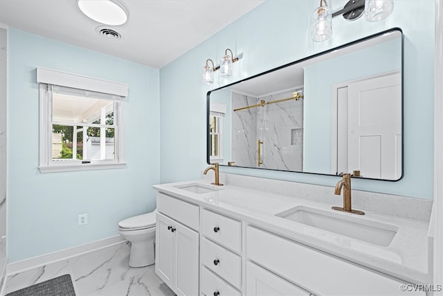 bathroom with vanity, toilet, and a shower