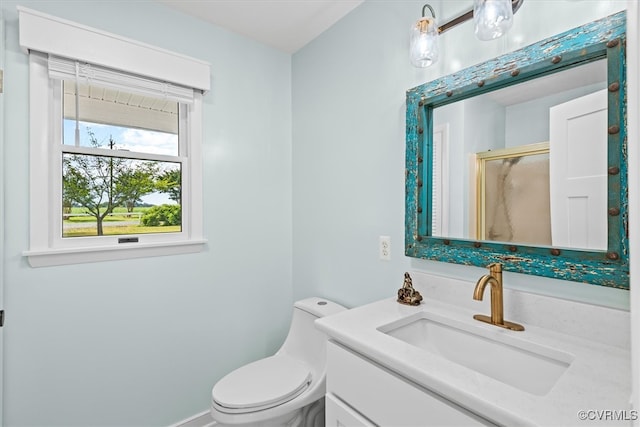 bathroom with vanity, toilet, and a shower with shower door