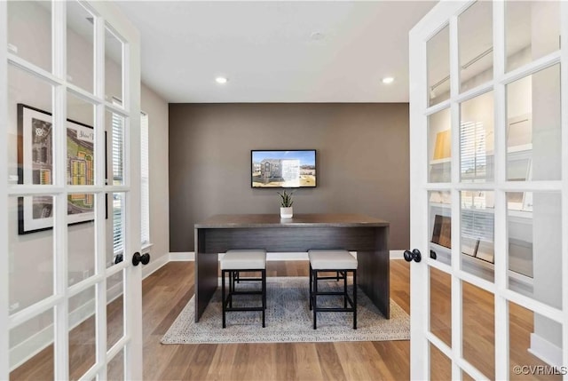 dining space with french doors and hardwood / wood-style floors