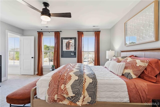 bedroom with ceiling fan and light colored carpet