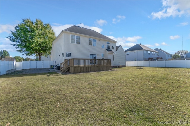 back of property with a wooden deck and a yard