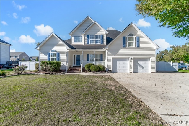 front of property featuring a front yard, a porch, and a garage